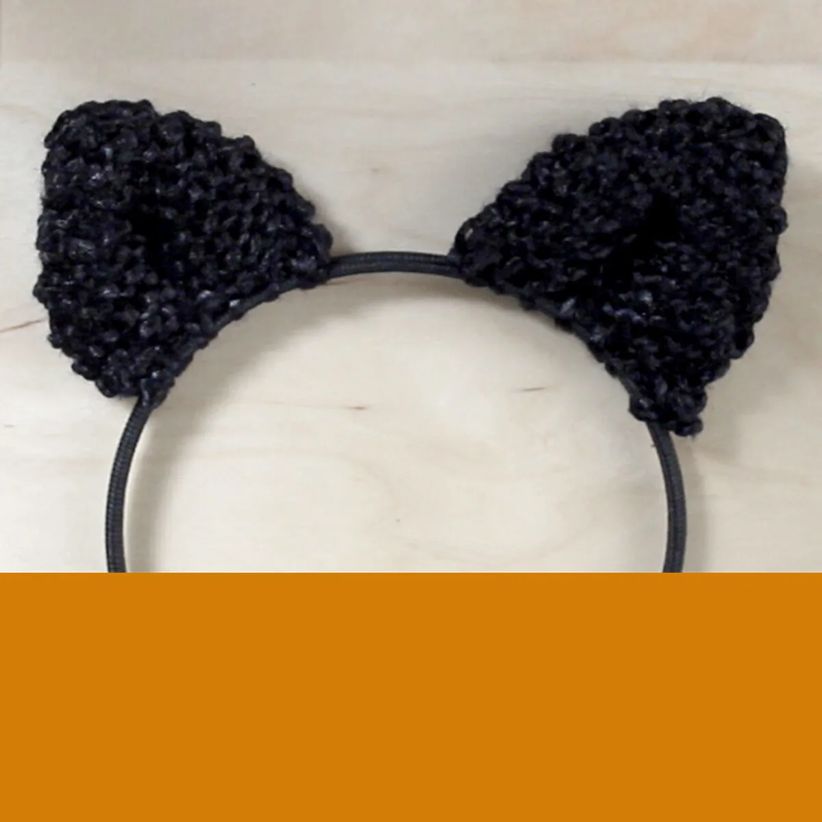 Knitted Cat Ears on a headband in black color yarn.