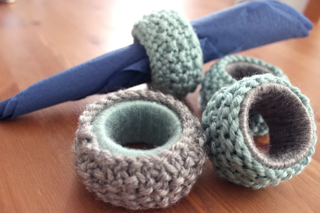 Knitted napkin rings on a table in gray and blue yarn