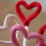 Knitting hearts bouquet in pink and red colors.