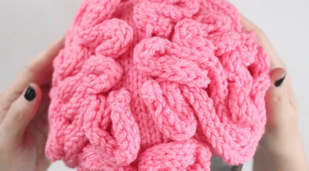 Knitted Brain Hat in pink yarn
