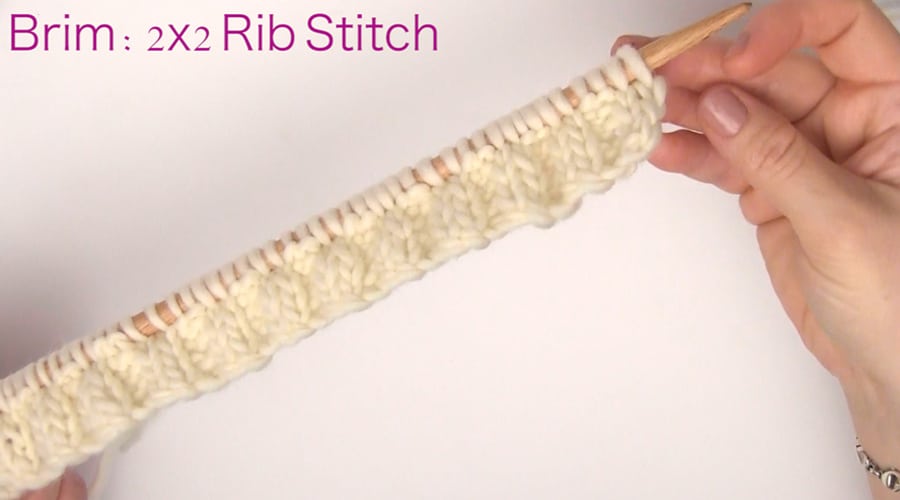 2x2 Rib Stitch Pattern. How to Knit a Messy Bun Hat Beanie Ponytails in 7 Easy Steps. Free Pattern + Video Tutorial by Studio Knit.