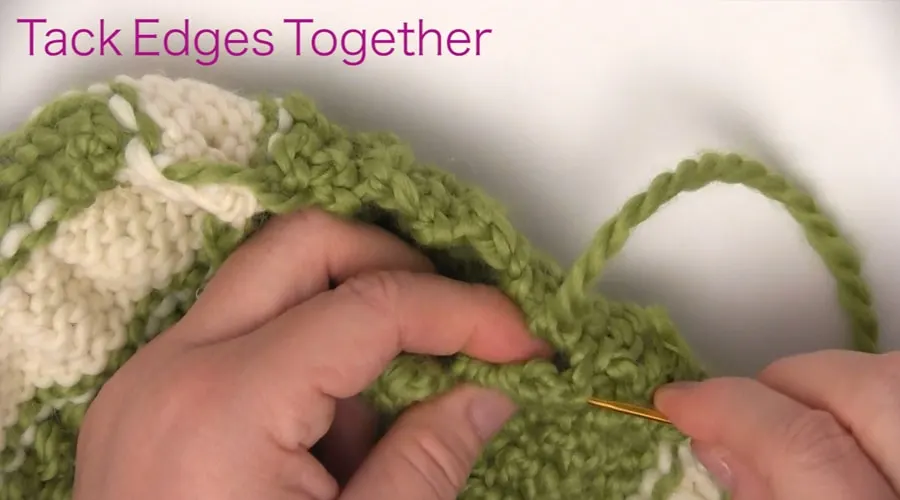 Tack Edges Together. How to Knit a Messy Bun Hat Beanie Ponytails in 7 Easy Steps. Free Pattern + Video Tutorial by Studio Knit.