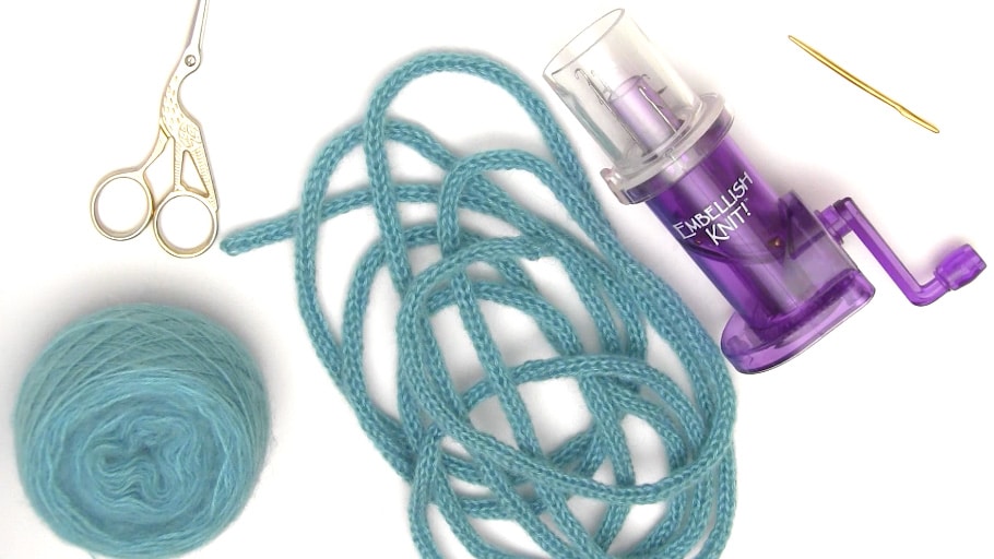 Yarn, knitted icords and an Embellish Knit device.