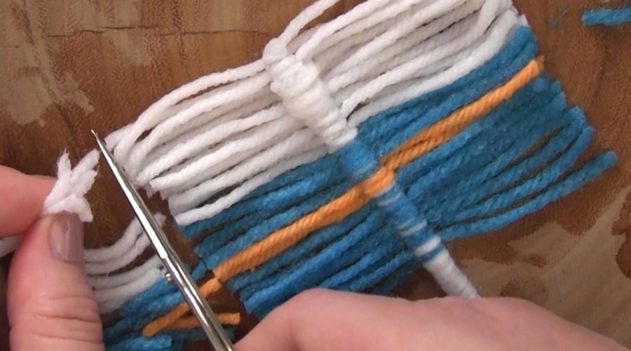 Cutting yarn ends of a fiber feather.
