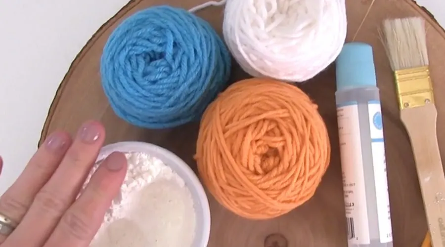 Yarn in blue, white, and orange colors with cornstarch.