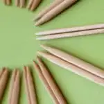 Straight knitting needles close up arranged in a circular configuration