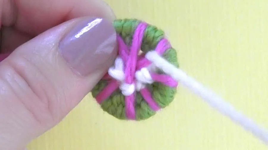 Weaving yarn to make a dorset button.
