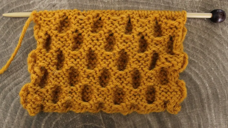 The wrong side of the Honeycomb knit stitch swatch on needle.