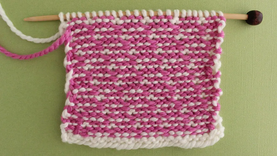 Back side of the Brick Stitch with pink and white yarn.