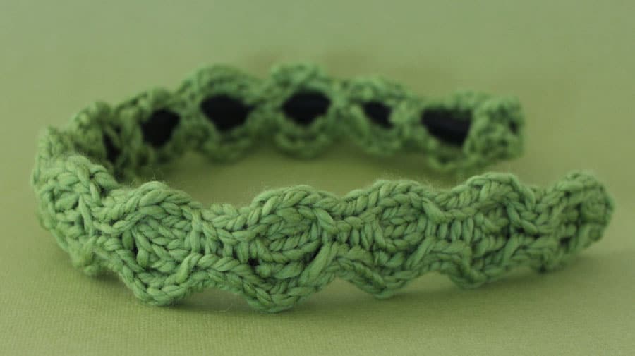 A Close-Up of a hairband knitted with green yarn
