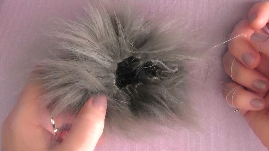 A cinched up faux fur pom pom before inserting the stuffing.