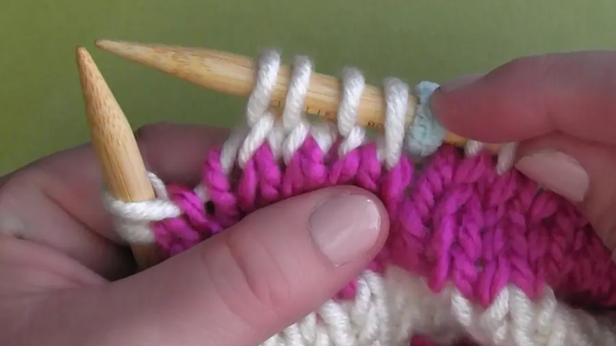 Close up of stitches on a knitting needle.