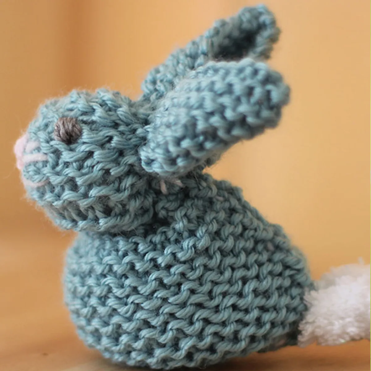 knitted bunny softie in garter stitch with blue yarn