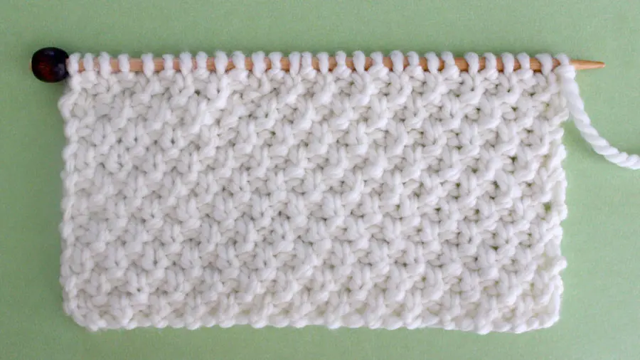 Irish Moss Knit Stitch Pattern. Get Free Written Patterns, Charts, and Video Tutorials in the Absolute Beginner Knitting Series by Studio Knit.