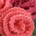 Knitted Rose shapes in peach and pink color yarn.