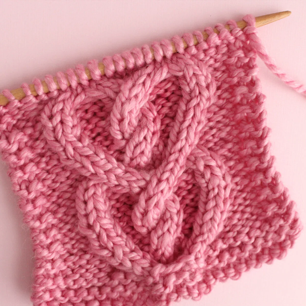 Cable Heart Knitting Pattern Swatch in Pink Yarn