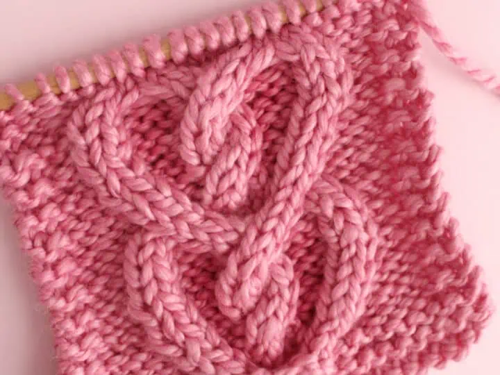 Cable Heart Knitting Pattern Swatch in Pink Yarn.