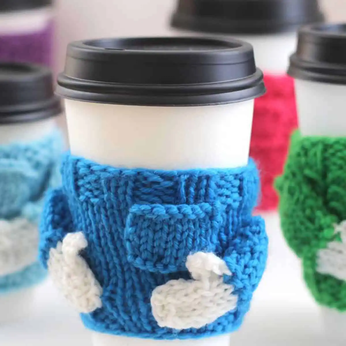 Knitted Coffee Cozy in sweater shape with blue yarn color.