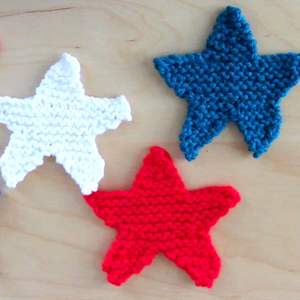 3 Knitted Star Shapes in red, white, and blue yarn colors.