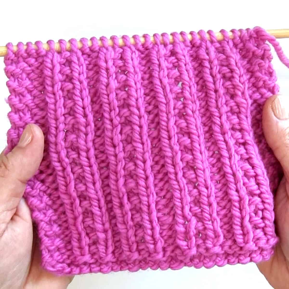 Beaded Rib Stitch Pattern knitted swatch in pink color yarn.
