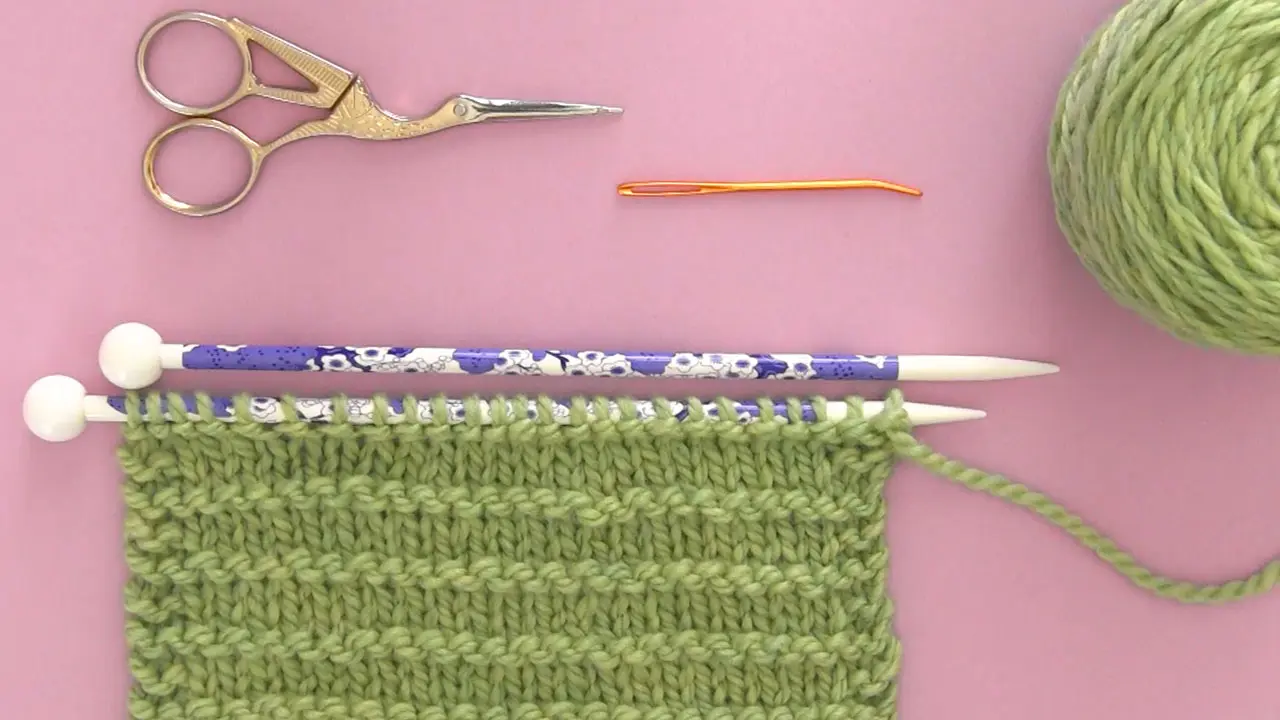 Knitting Materials yarn, knitting needles, scissors, and tapestry needle