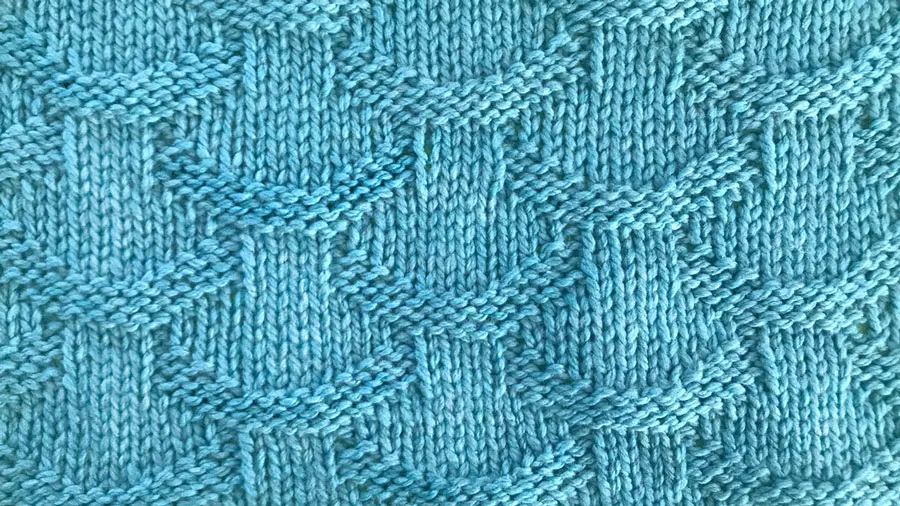 Close up a swatch of textured Basket Loop Stich in blue yarn