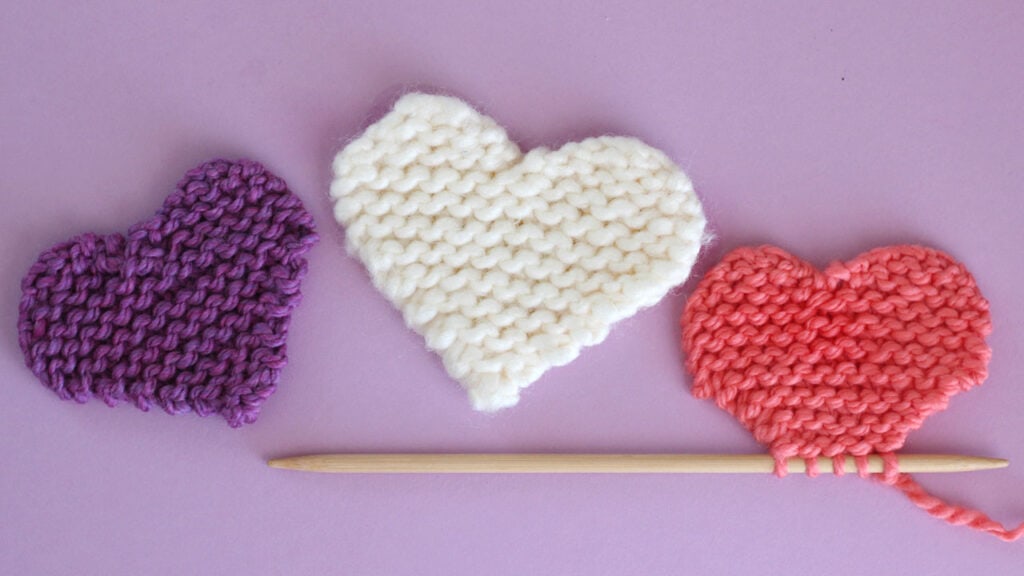 three knitted hearts in garter stitch