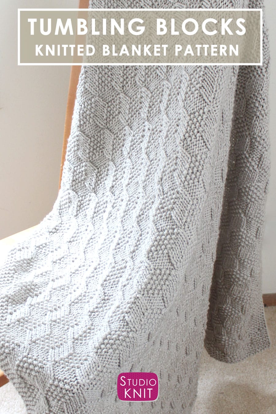 Knitted Blanket in Tumbling Moss Blocks Stitch draped over wooden chair