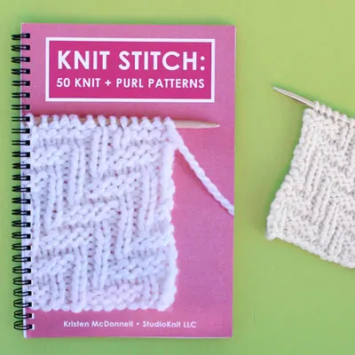 Knit Stitch Pattern Book with Lay Flat Wire-O Binding and Knitted Swatch on Green Background.
