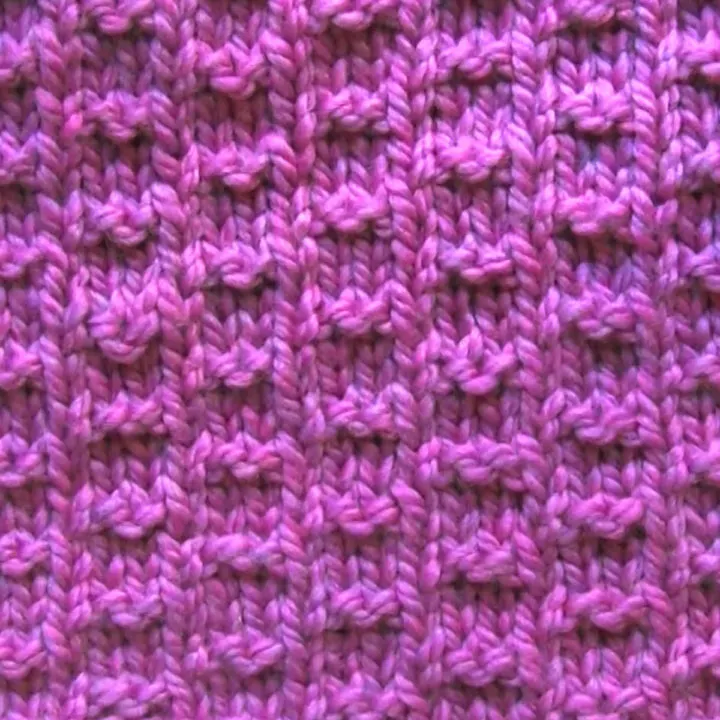Double Fleck Knitting Pattern in Purple Yarn.