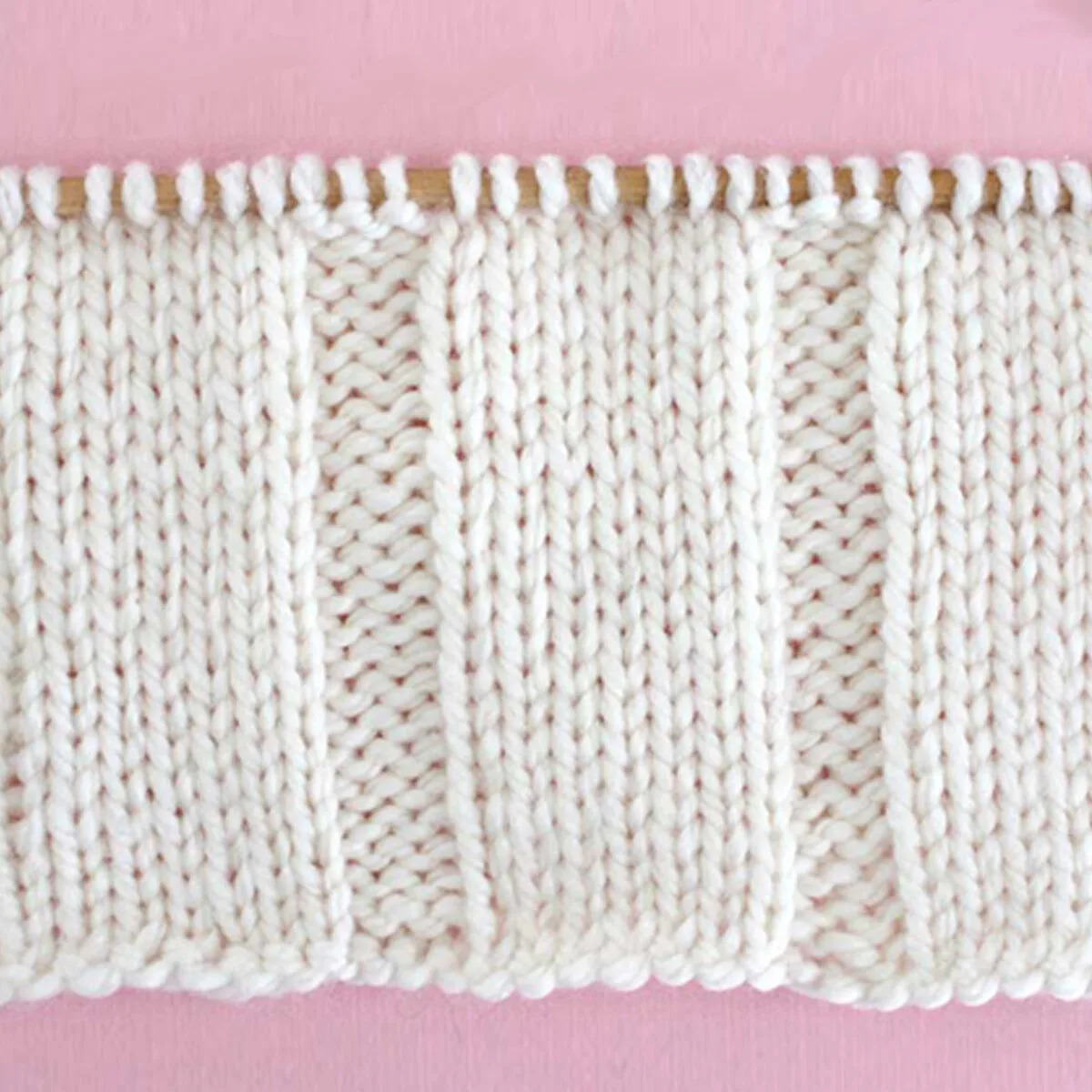 7x3 Rib Knit Stitch Pattern in white yarn on knitting needle.