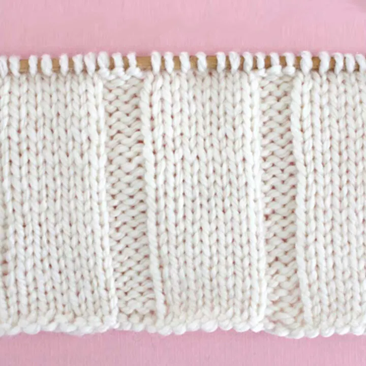 7x3 Rib Knit Stitch Pattern in white yarn on knitting needle.