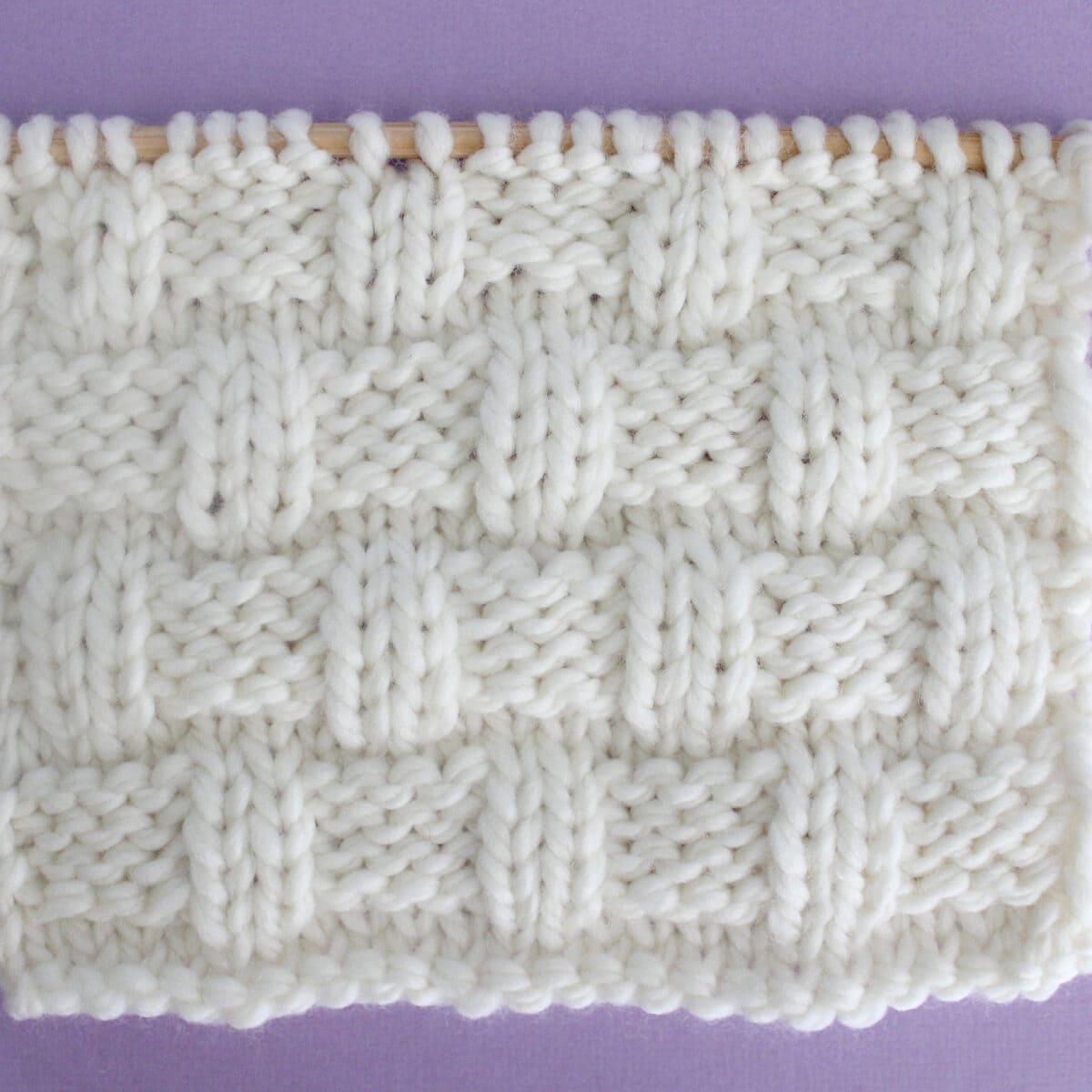 Basket Weave Stitch Knitting Pattern in white yarn color on knitting needle.