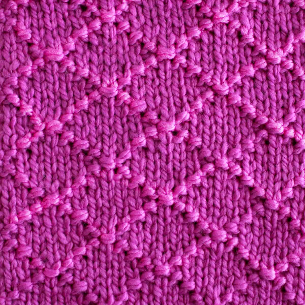 Diamond Brocade Knit Stitch Pattern texture in purple color yarn.