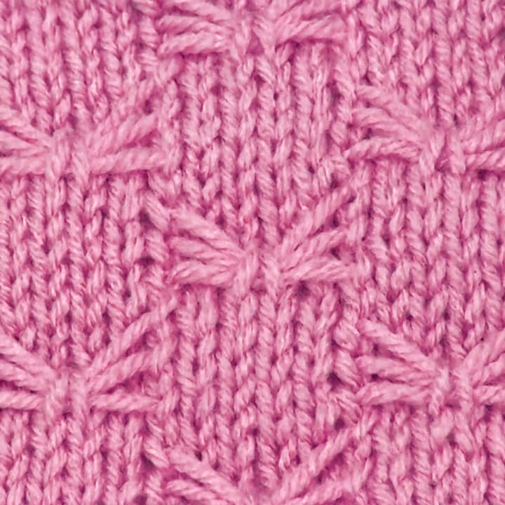 Knitted butterfly stitch pattern in pink color yarn.
