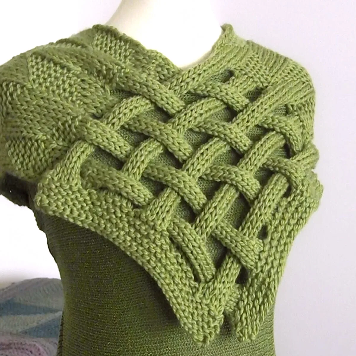 Celtic Saxon Braided Scarf in green yarn on mannequin.