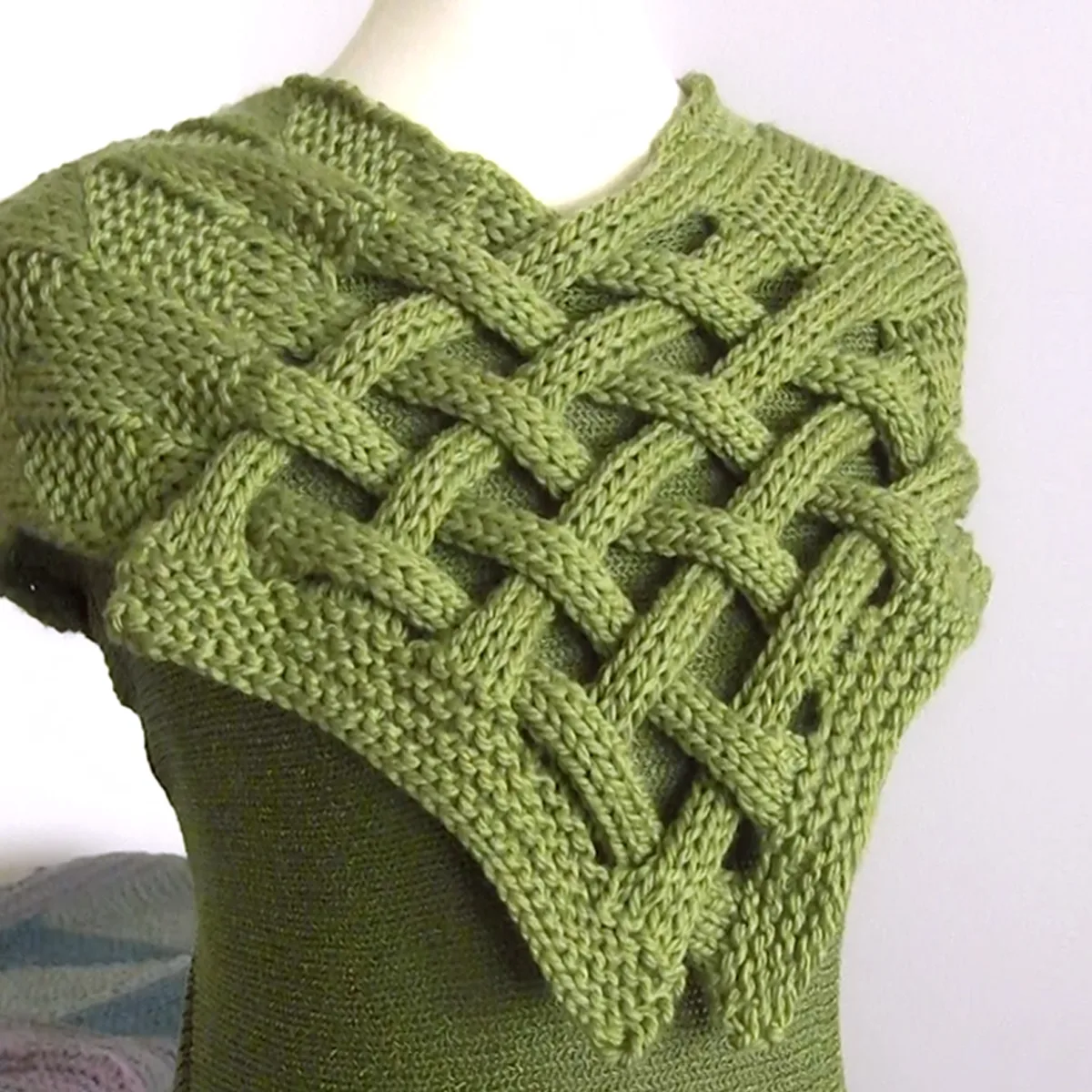Celtic Saxon Braided Scarf in green yarn on mannequin.