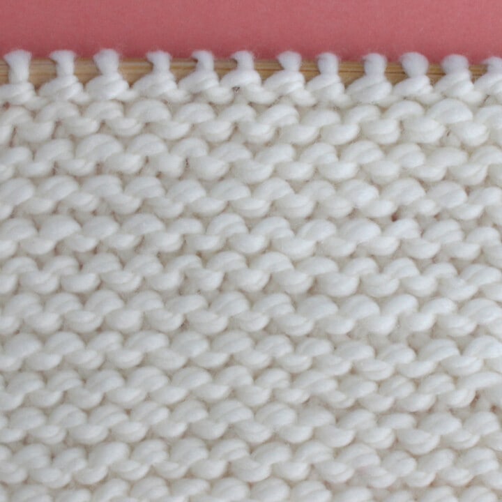 Garter Knit Stitch Pattern with white yarn color on a knitting needle.