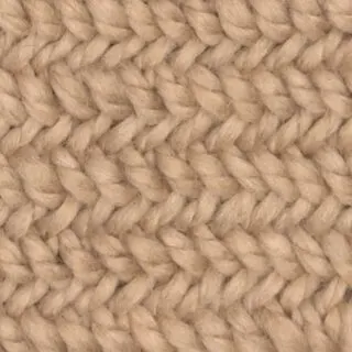 Knitted Herringbone Stitch Pattern texture in beige color yarn.