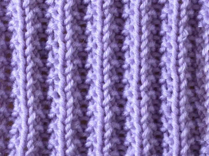 Seeded Rib Knit Stitch Pattern in purple yarn.