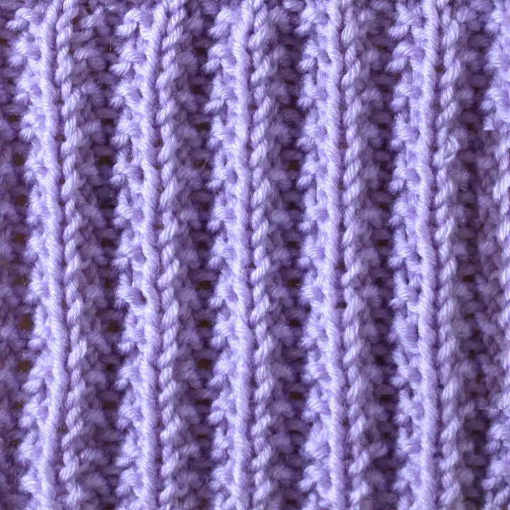 Seeded Rib Knit Stitch Pattern in purple yarn.