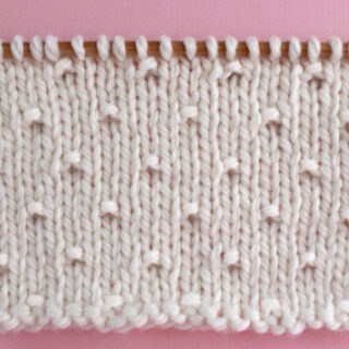 Simple Seed Knit Stitch Pattern in white yarn color on knitting needle.
