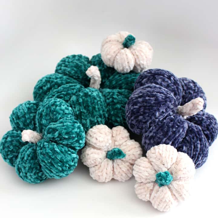 Knitted Pumpkin Softies in blue, green, and white yarn colors with velvet yarn.