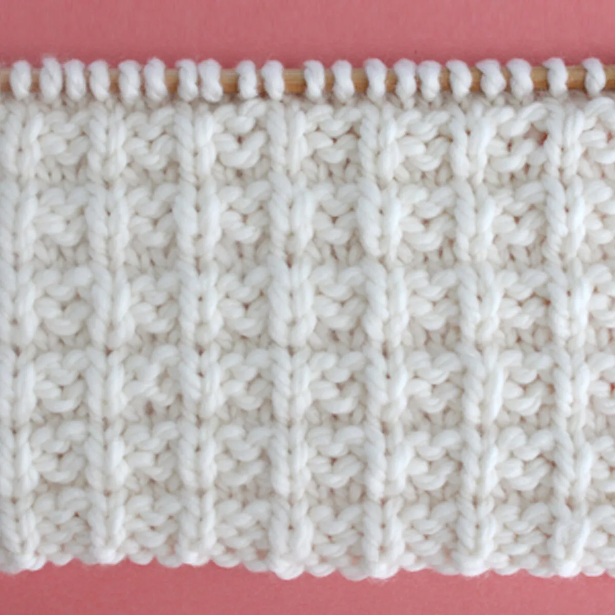 Waffle Stitch Knitting Pattern in white yarn color on knitting needle.