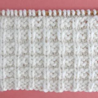 Waffle Stitch Knitting Pattern in white yarn color on knitting needle.