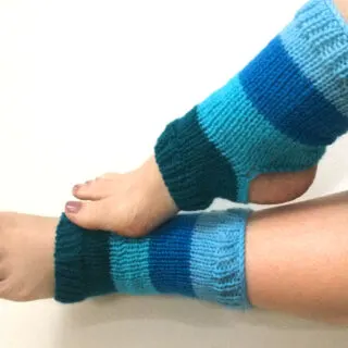 Knitted Yoga Socks on two feet in blue yarn colors.