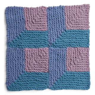 Knitted Square in the Attic Windows Design with shades of blue and purple yarn colors.