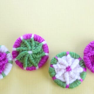 Dorset Buttons in white, green, and pink color yarn.