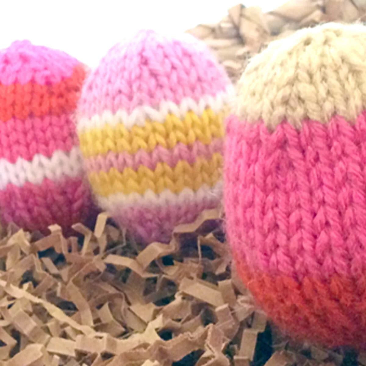 Knitted Easter Egg Softies in yellow and pink yarn colors.