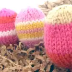 Knitted Easter Egg Softies in yellow and pink yarn colors.